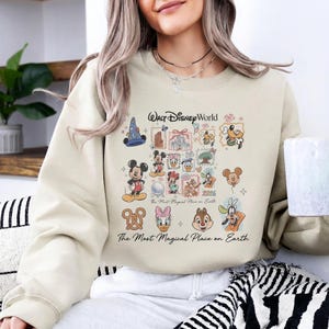 Sand colored oversized sweatshirt with Walt Disney World magical place on earth graphic for theme park trips.