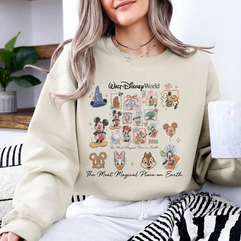 Sand colored oversized sweatshirt with Walt Disney World magical place on earth graphic for theme park trips.