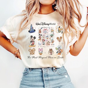 Close-up of a vanilla colored comfort colors shirt with retro Disney world character art and 2026 branding.
