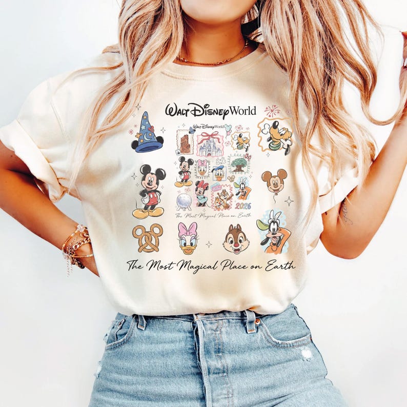 Close-up of a vanilla colored comfort colors shirt with retro Disney world character art and 2026 branding.