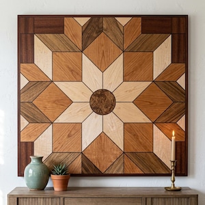 May include: A square wooden wall art piece featuring a geometric star pattern composed of various wood tones including light maple, medium cherry, and dark walnut, with a circular burl wood center, framed in a dark wood border.