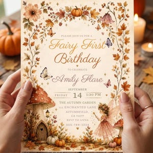 May include: A rectangular invitation card with a cream background featuring an autumn-themed border of orange leaves, pumpkins, and butterflies. The text reads: Please join us for a Fairy First Birthday to celebrate Amily Flare, Friday, September 14, 1:30 PM.