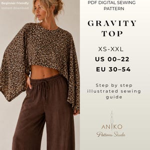 May include: A PDF digital sewing pattern for the Gravity Top, available in sizes XS-XXL, US 00-22, and EU 30-54. The image displays a cropped top with a brown and black leopard print and wide sleeves, paired with solid brown drawstring trousers.