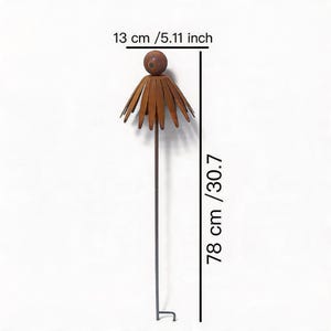 May include: A metal garden stake with a flower design. The stake is 78 cm (30.7 inches) tall and 13 cm (5.11 inches) wide. The flower petals and the top sphere are brown. The stake has a hook at the bottom.