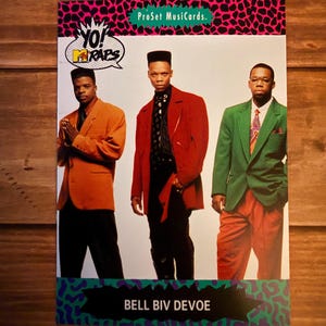 May include: A ProSet Musicards trading card featuring the group Bell Biv DeVoe. The card has a pink and black spotted border with the text "Yo! Raps" and the group's name. The three men are wearing suits in orange, red, and green.