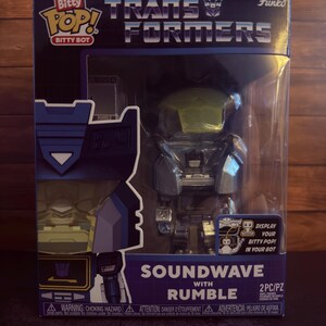 May include: A Bitty Pop! Transformers Soundwave with Rumble vinyl figure set in its original packaging. The box features the Transformers logo, the Bitty Pop! branding, and text identifying the characters. The clear window displays the robot figures.