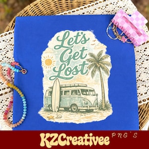 May include: A royal blue t-shirt featuring a graphic print of a vintage van, a surfboard, a palm tree, and a sun with the text Let's Get Lost. The shirt is displayed with a multi-colored beaded necklace and a pink checkered hair claw clip.