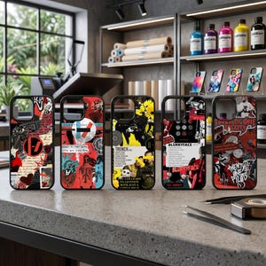 May include: Five phone cases with distinctive designs are displayed. The cases feature a mix of colours, including red, black, and yellow, with graphic text and imagery. The cases are presented on a grey countertop, showcasing a range of artistic styles.