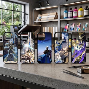 May include: Five black phone cases with colorful anime-style character designs. The cases feature various characters in action poses, with detailed artwork and vibrant colors. The cases are displayed on a gray surface.