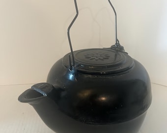 Vintage cast iron black kettle with medal handle