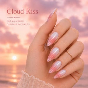 May include: A hand with long, almond-shaped nails painted with a gradient of white to pink. The nails are the focal point, with a gold ring on the ring finger. The background is a soft, pink sunset with the text "Cloud Kiss".