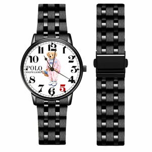 May include: A black metal wristwatch with a white dial featuring a graphic of a bear wearing a pink outfit. The watch face displays the text POLO RALPH LAUREN, black Arabic numerals, and a red number five. It includes a matching black metal link band.