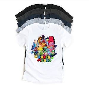 May include: A stack of t-shirts in various colors, including white, gray, navy, and black. The front white shirt features a colorful graphic of Super Mario characters with the text "Super Marco" and the number "8".