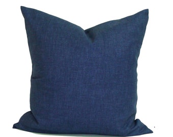 May include: A square, navy blue decorative pillow with a textured fabric. The pillow has a classic, tailored appearance, suitable for a sofa or bed. The solid color and simple design make it versatile for various interior styles.