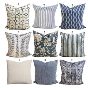 May include: A collection of nine square throw pillows arranged in a grid, numbered one through nine. The pillows feature various patterns including geometric shapes, vertical stripes, floral motifs, and abstract textures in shades of blue, white, and beige.