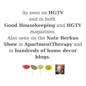 May include: White background with text: "As seen on HGTV and in both Good Housekeeping and HGTV magazines. Also seen on the Nate Berkus Show in ApartmentTherapy and in hundreds of home decor blogs." Includes floral illustrations.