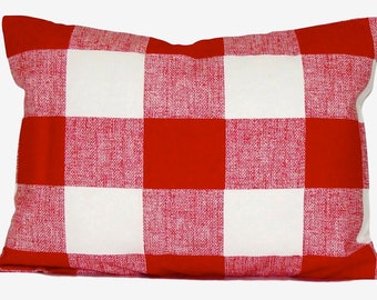 May include: A rectangular pillow with a red and white checkered pattern. The pillow's design features large, evenly sized squares of red and white, creating a classic gingham or buffalo check appearance. The fabric has a textured look.