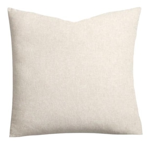 May include: A square throw pillow cover in a solid, light beige color. The fabric features a visible, fine-grained woven texture throughout the surface, creating a neutral and consistent appearance across the entire front of the square cushion.