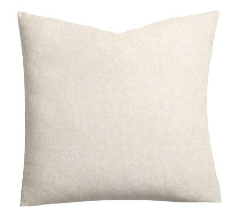 May include: A square throw pillow cover in a solid, light beige color. The fabric features a visible, fine-grained woven texture throughout the surface, creating a neutral and consistent appearance across the entire front of the square cushion.