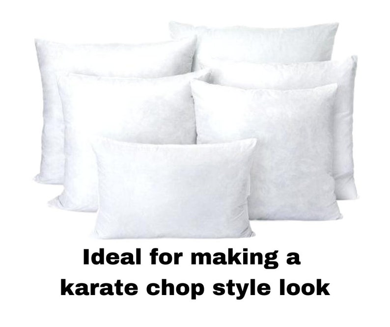 May include: A collection of white square and rectangular pillows. The pillows are arranged in a group, with some overlapping. The text at the bottom reads: "Ideal for making a karate chop style look."