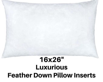 May include: A white rectangular feather down pillow insert, measuring 16x26 inches. The pillow is fluffy and filled with down feathers. Text on the image reads "16x26" Luxurious Feather Down Pillow Inserts."