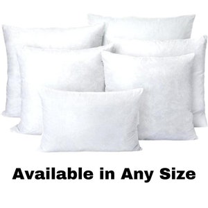 May include: A collection of white pillow inserts in various shapes and sizes. The image shows several rectangular and square pillows, all with a fluffy, filled appearance. Text at the bottom reads "Available in Any Size."