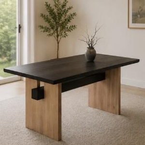 May include: A rectangular dining table with a dark brown tabletop and light brown wooden legs. The table is approximately 72 inches long and 36 inches wide. A small vase with branches sits on the table. The table is in a well-lit room with a neutral color palette.
