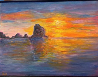 Sunset on the Coast A vivid sunset fills the sky with purple, blue, and fiery orange tones, reflected in the ocean below.