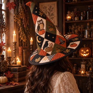 May include: A quilted witch hat featuring a patchwork design of autumn-themed motifs including owls, pumpkins, crows, crescent moons, and maple leaves in a color palette of black, orange, cream, and olive green with a black fabric trim.