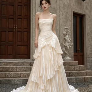 white by vera wang asymmetric pleats wedding dress HAYLEY // Strapless soft ball gown with draped corset bodice and asymmetrically swept floating organza petal skirt with pleated tulle. Photography: @candid_chaser Make-up: @carlyburgessmakeup Location: @bimbadgen Flowers: @flowers_bygrace @VeraWangGang