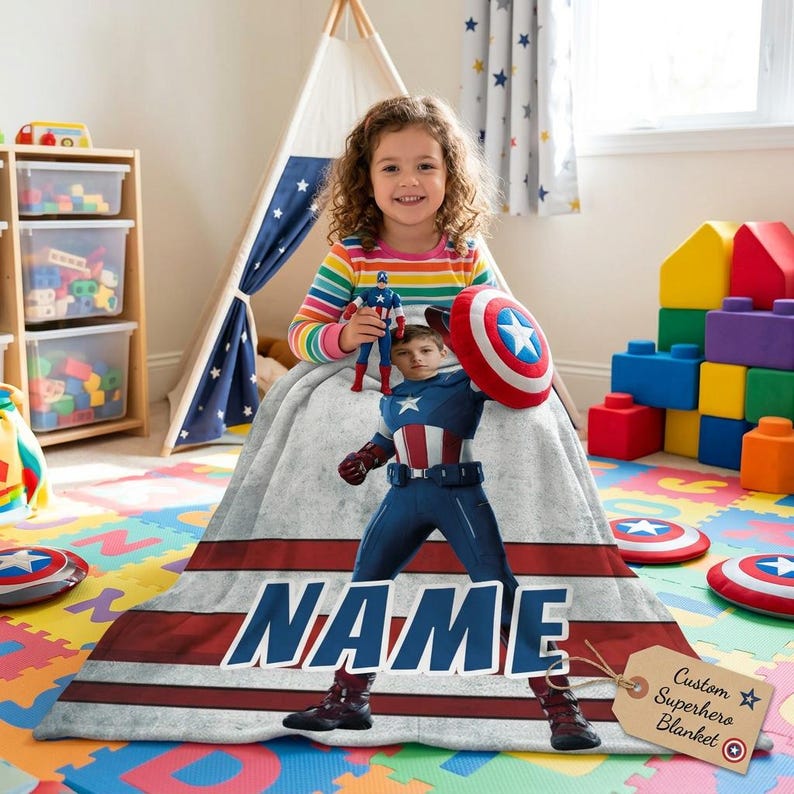 May include: A personalized superhero blanket featuring a Captain America design with the name "NAME" in large blue letters. The blanket has a red and white striped border and includes a tag that says "Custom Superhero Blanket".