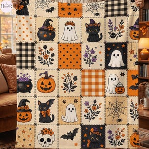 May include: A patchwork blanket featuring a repeating Halloween pattern of black cats, ghosts, pumpkins, bats, skulls, spiderwebs, and floral motifs in orange, black, and cream. The design includes checkered and polka dot squares throughout the fabric.