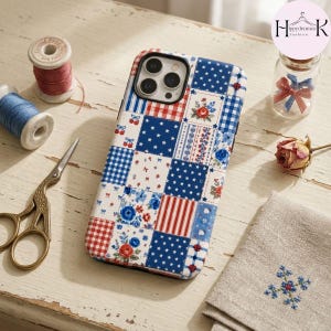 May include: A smartphone case featuring a patchwork design of red, white, and blue squares. The pattern includes floral motifs, gingham checks, stripes, and white stars on a blue background. The case has a cutout for a triple-lens camera system.