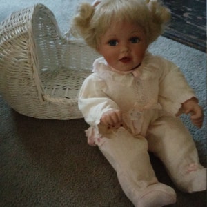 Adorable Vintage Porcelain Baby Doll With Bonus Chippy White wicker cradle, Porcelain doll eating chocolate chip cookie