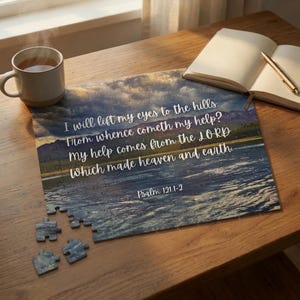 May include: A rectangular jigsaw puzzle featuring a landscape of mountains and water with the white text: I will lift my eyes to the hills. From whence cometh my help? My help comes from the LORD which made heaven and earth. Psalm 121:1-2.