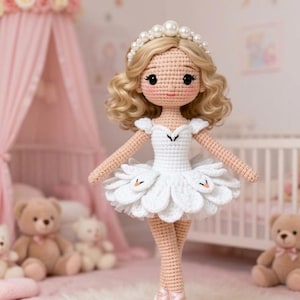 May include: A handcrafted crochet doll with blonde curly hair, wearing a white tutu dress and a pearl-studded headband. The doll has rosy cheeks and is posed in a ballet stance. The background includes a pink canopy and teddy bears.