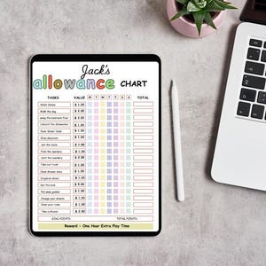 May include: A digital allowance chart on a tablet, titled "Jack's Allowance Chart" in colorful letters. The chart lists tasks with corresponding values and spaces for tracking daily completion. A stylus, laptop, and small potted plant are also visible.