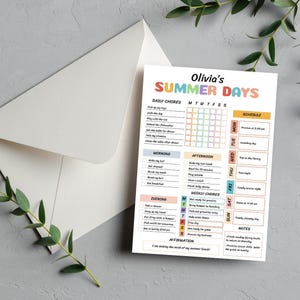 May include: A white card with a colourful "Olivia's SUMMER DAYS" checklist, with daily, morning, afternoon, evening, and weekly chores. The card is inside a white envelope, with a sprig of greenery in the corner.