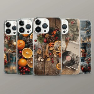 May include: Five clear phone cases featuring holiday-themed designs including a gift box, oranges with pine cones, cinnamon sticks with dried citrus, a vintage record player with a vinyl disc, and a nutcracker figure against a snowy background.