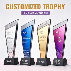 May include: Four customized trophies with black bases and angled, colorful tops. The trophies have text that reads "CUSTOMIZED TROPHY" and "4 Colors Available". Each trophy has a different design and text, including "NUS", "First", and "Microsoft".