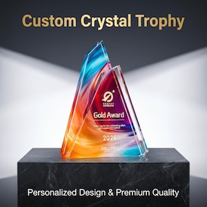 May include: A custom crystal trophy with a colorful design, featuring blue, orange, and red hues. The trophy is a Gold Award for 2026, with the text "Custom Crystal Trophy" and "Personalized Design & Premium Quality".