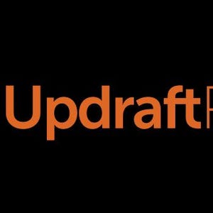May include: The UpdraftPlus logo on a black background. The logo features a white upward-pointing arrow inside an orange circle, with the words "UpdraftPlus" in orange to the right.