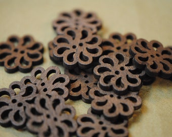 May include: A collection of brown wooden buttons with a floral design. The buttons are intricately carved with a delicate pattern.