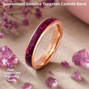May include: A rose gold tungsten carbide band featuring a central inlay of crushed magenta purple stone. The interior of the ring is engraved with the text "Love you hubby x". The text "Guaranteed Genuine Tungsten Carbide Band" and "Free Customized Engraving Inside" appear in the image.