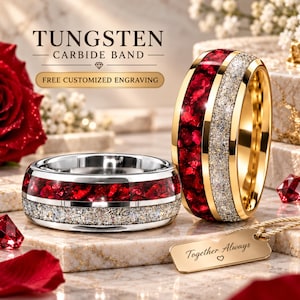 May include: Two tungsten carbide bands featuring a central inlay of crushed red stone and a textured silver-toned glitter band. The rings are displayed with a gold-toned metal tag engraved with the text Together Always and a small heart symbol.