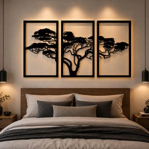 May include: A triptych wall art set featuring a black metal silhouette of a sprawling tree across three rectangular frames. Each frame is backlit, casting a warm glow against the wall behind the bed, creating a layered visual effect.