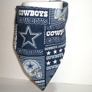 May include: A blue and white fabric bandana featuring the Dallas Cowboys logo and the word "Cowboys" repeated throughout the design.