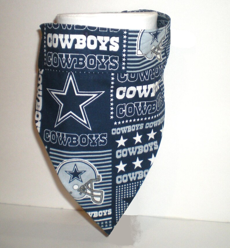 May include: A blue and white fabric bandana featuring the Dallas Cowboys logo and the word "Cowboys" repeated throughout the design.