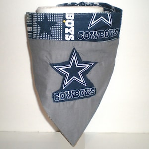 May include: Grey dog bandana with a blue star and the word "COWBOYS" in white lettering.