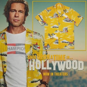 May include: Yellow short-sleeve shirt with a landscape print. The shirt features a button-down front and a classic collar. The image also includes a white t-shirt with the word "Hampion" and the text "ONCE UPON A TIME IN... HOLLYWOOD NOW IN THEATERS".